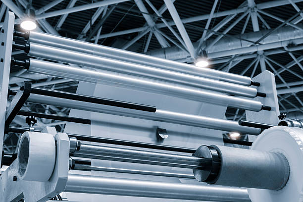 istock Automatic polyethylene plastic bag production machine with lighting effect. Close-up of the roller of the plastic bag production machine in the light blue scene. product packaging concept 2251036879