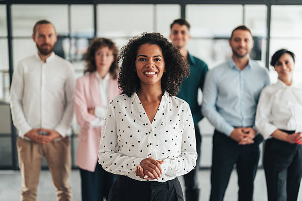 istock Successful team leader and her team behind her 2251037198