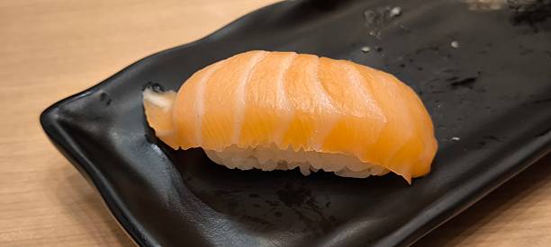 istock Sushi on a black plate on a wooden table 2251038731