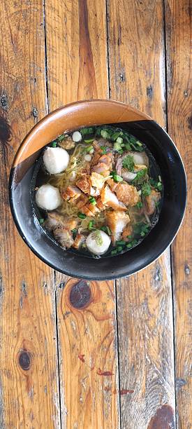 istock Noodle soup in a ceramic bowl on a wooden table 2251038923