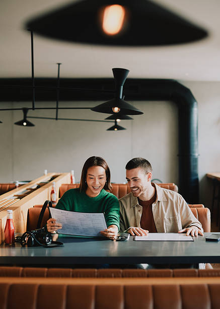 istock A young couple in a restaurant looking at the menu 2251039924
