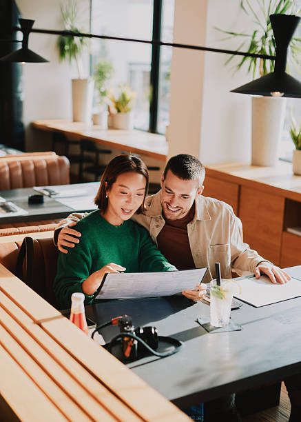 Joyful Married Couple Enjoying a Warm Dining Experience at a Modern Restaurant