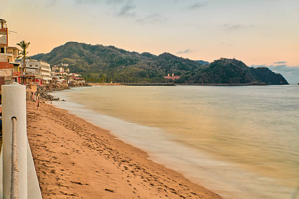 istock sunset on the beach and the sun is setting on the horizon 2251048312