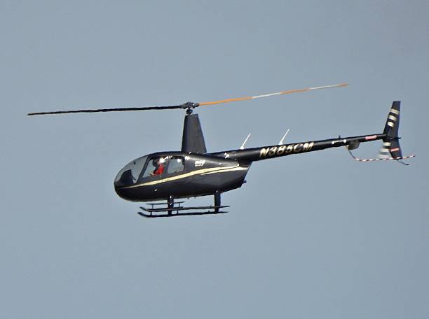 Boca Raton, Palm Beach County, Florida – USA, December 8, 2025. A Robinson helicopter (4 seats / 1 engine) N385CM taking off from the Boca Raton Airport.
