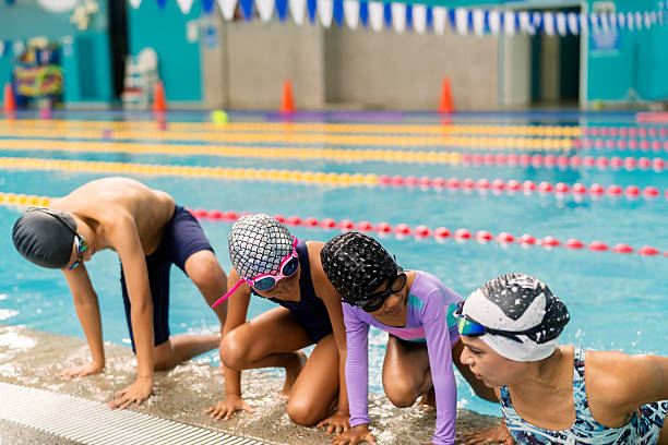 istock Children getting ready to jump into swimming pool 2251054707
