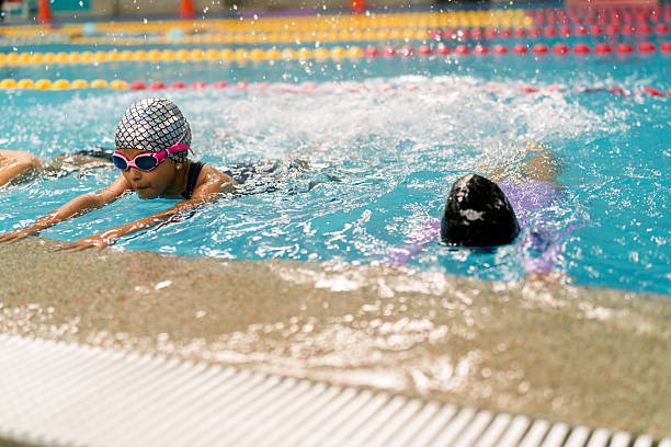 istock Child learning to swim in pool during lesson 2251054766