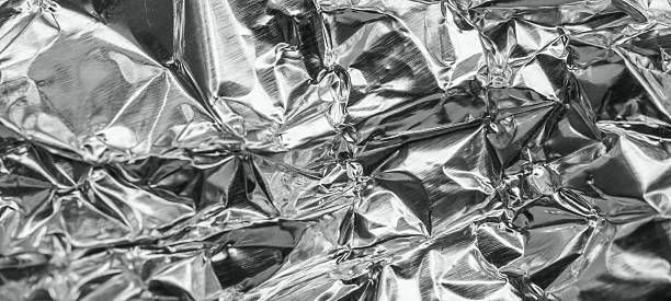 istock Shiny metal silver gray foil leaf crumpled texture background 2251058496