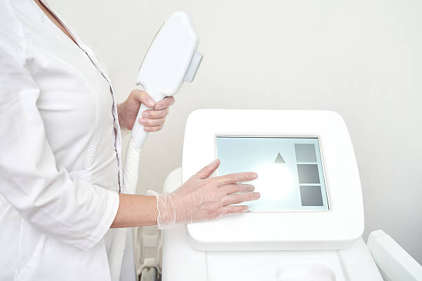 istock Female technician operating medical laser equipment with touchscreen in modern 2251058541