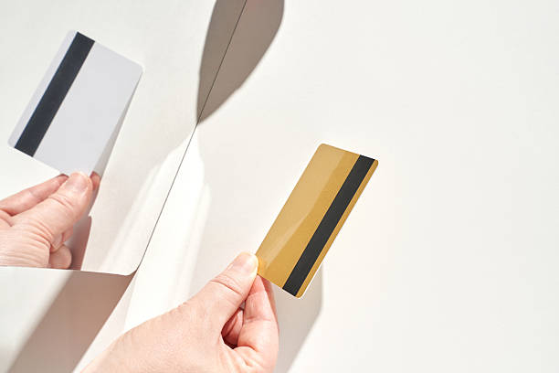 istock Hands holding credit card and mirror reflection on white background 2251058575