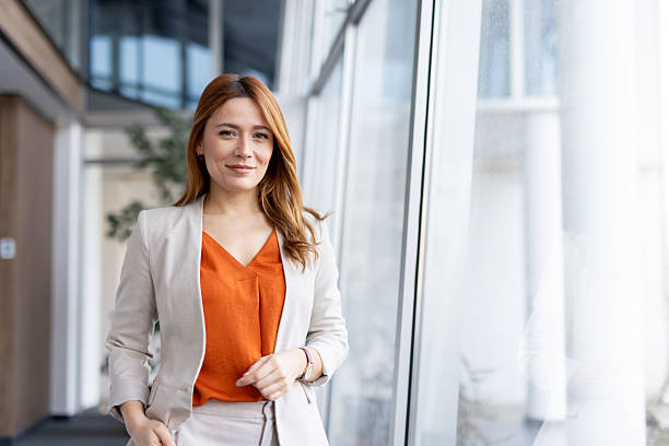 istock Elegant woman walking confidently by office windows 2251059739