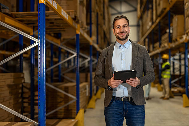 istock Confident Manager Standing in a Warehouse Holding a Digital Tablet 2251059749