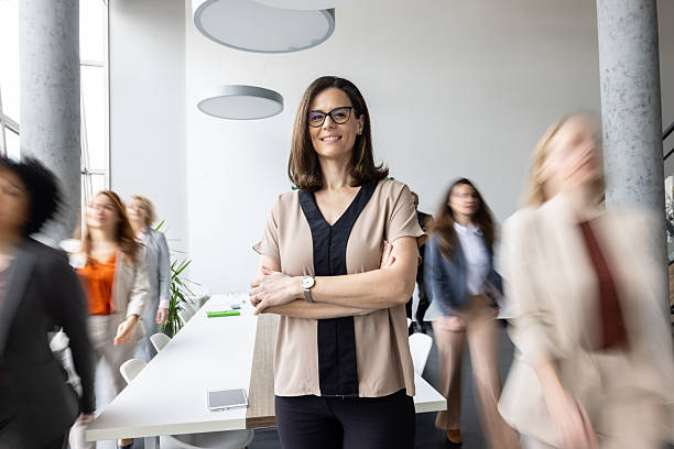 istock Professional woman posing confidently in a busy office setting 2251059752
