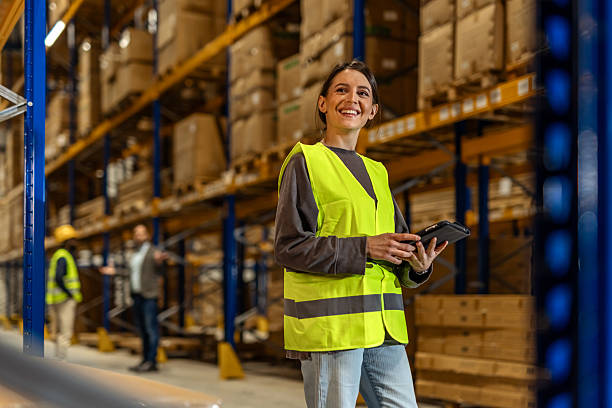 istock Warehouse Employee Smiling While Using Tablet in Industrial Storage Area 2251059755