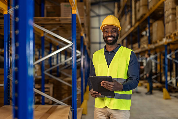 istock Smiling Warehouse Worker Holding Tablet in a Storage Facility 2251059814