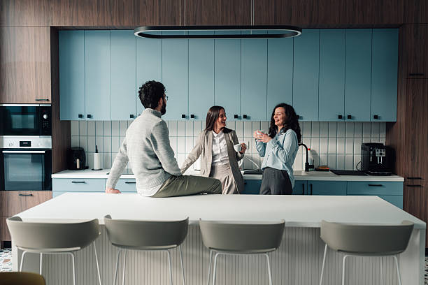 istock Coworkers enjoying coffee break and social interaction in office kitchen 2251064260