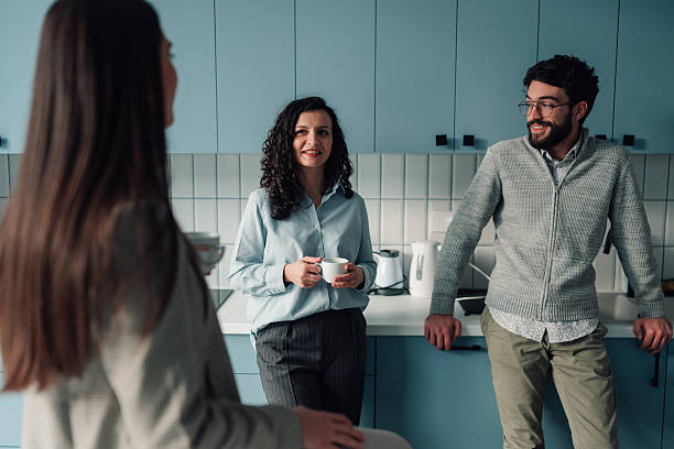 istock Colleagues talking and enjoying coffee break in office kitchen 2251064275