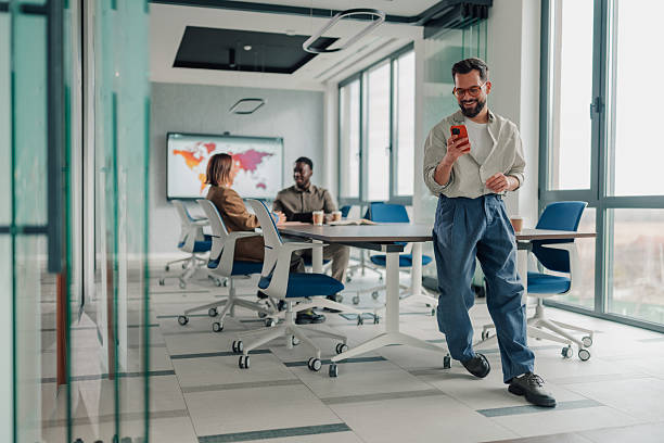 istock Business man checking smartphone during office meeting 2251064561