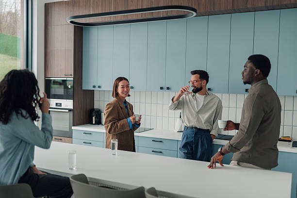 istock Diverse coworkers taking coffee break in modern office kitchen 2251064631