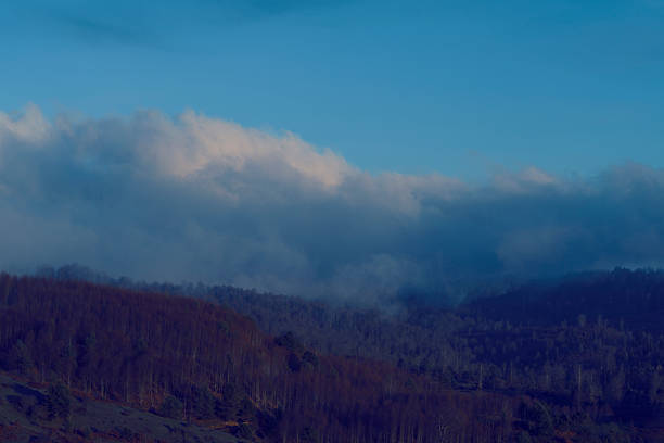 Giant rain clouds are gathering over the mountain