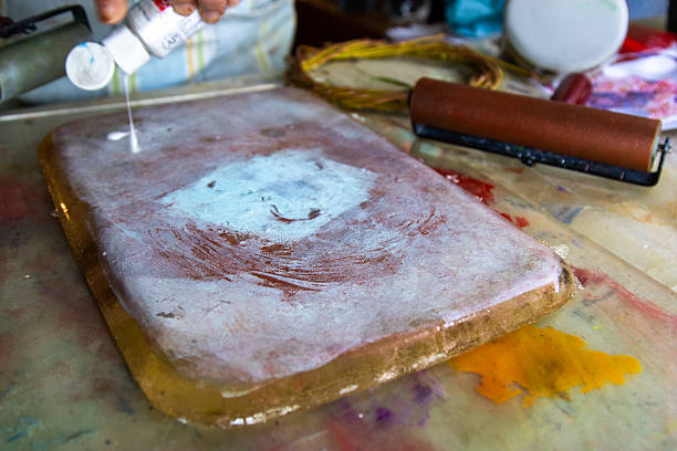 istock Pouring robin’s egg blue acrylic paint onto a gelli printing p 2251080160