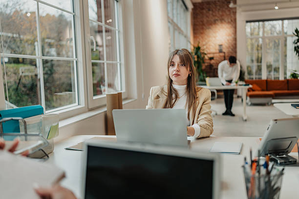 istock Young people working together in a modern office space with screens and natural light during a daytime setting 2251081466