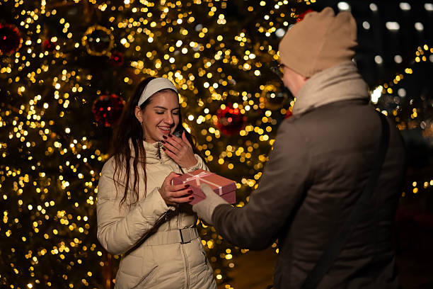 istock Couple exchanging christmas gift appreciating holiday surprise 2251082352