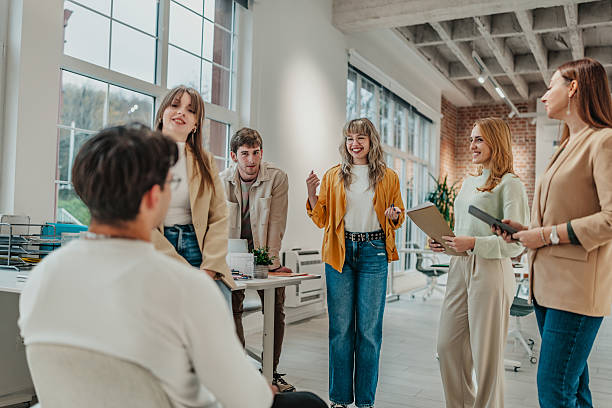 istock Group of young adults collaborating in a modern office environment during a work meeting 2251083035
