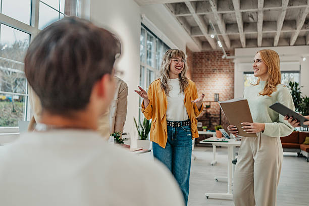 istock Group of young adults discussing project ideas in a modern office space during a work session in a collaborative setting 2251083052