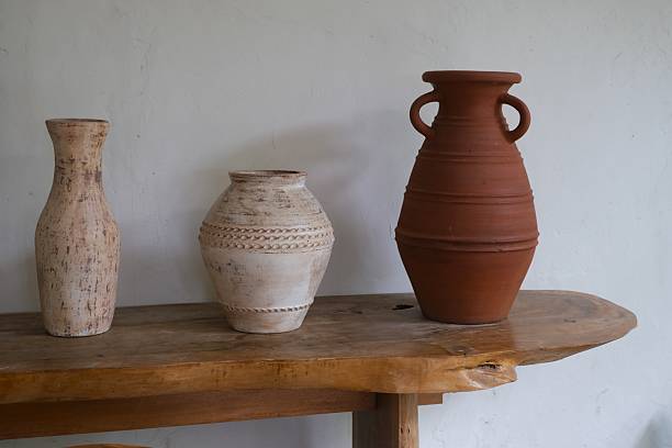 istock Rustic Clay and Ceramic Vases on Wooden Table 2251084115