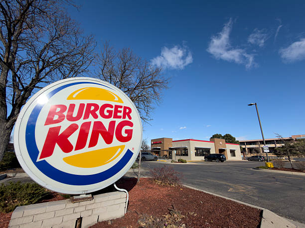 Boulder, Colorado, USA - November 27, 2025: Burger King restaurant sign with building and blue sky