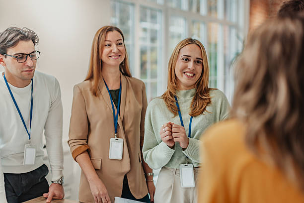 istock Group of young professionals in an office discussing work tasks during a meeting in a modern workspace 2251086592