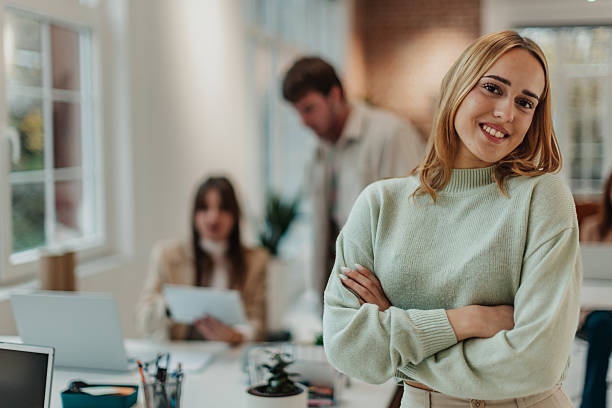 istock Young adults working together in an office setting focused on collaboration and teamwork with modern technology 2251086939