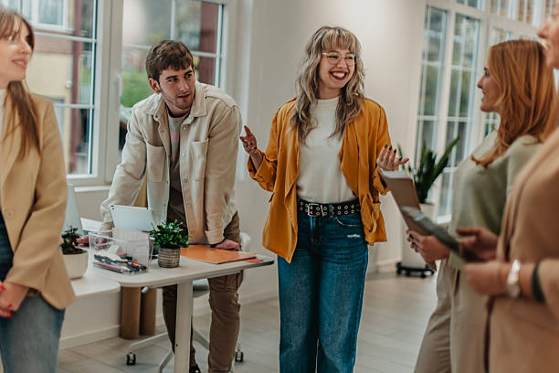 istock Young adults collaborate in a modern office space discussing projects and sharing ideas during working hours 2251088397