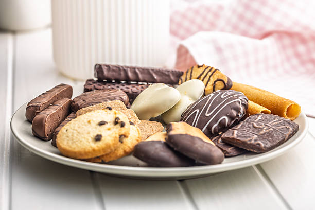 Christmas sweet and cookies on plate on a white table.
