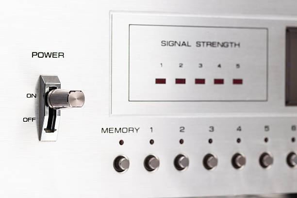 Close-up of a classic audio component showcasing details of its knobs, signal strength indicator, and power switch, representing vintage aesthetics and design of mid-century technology.