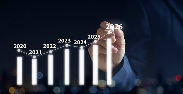 istock close up businessman hand use stylus pen to write virtual statistic graph about business plan and target of company over black background for future and 2026 new year goal concept 2251100636