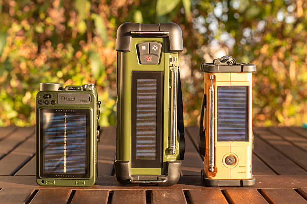 istock Three Compact Solar Radio Devices on Wooden Table in Outdoors Setting 2251102738