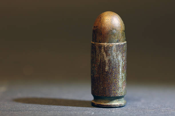 Single 9×19mm Parabellum Cartridge on a Matte Black Background