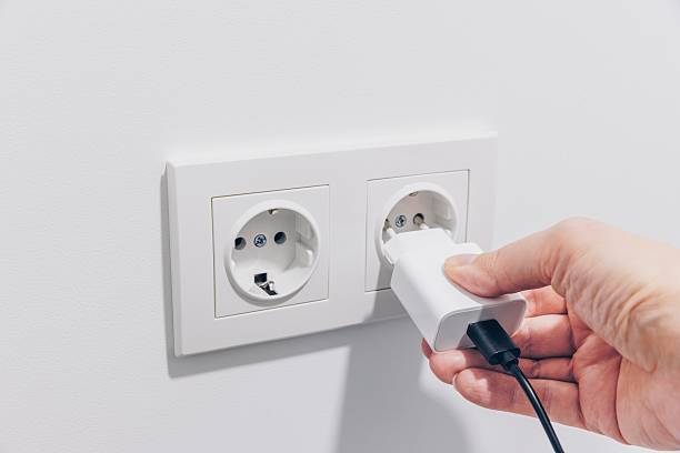 istock A Close-Up View of a Hand Inserting a Charging Plug into an Electrical Wall Outlet, Highlighting Modern Power Connectivity in Daily Life 2251106627