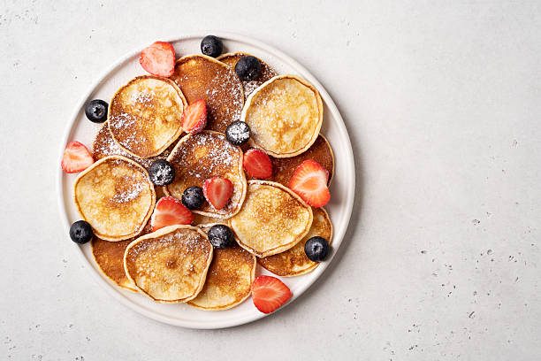 istock Mini pancakes with blueberries and strawberries 2251110771