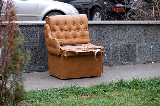 istock Discarded armchair rests forgotten on a city sidewalk 2251112765