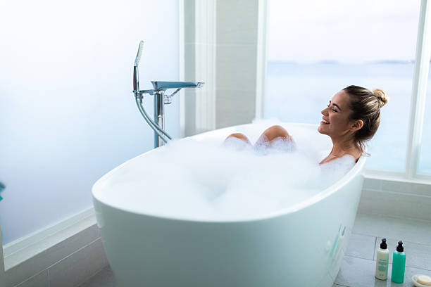 istock Happy woman enjoying while having bubble bath in a bathroom. 2251112801