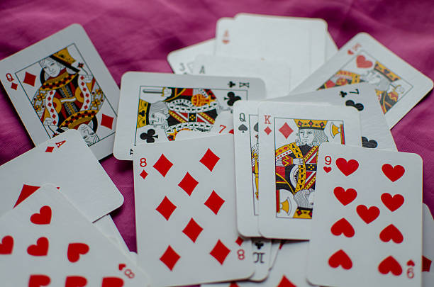 istock A deck of playing cards is scattered on the pink background. 2251115087