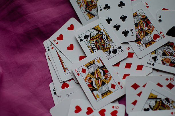 istock A deck of playing cards is scattered on the pink background. 2251115121