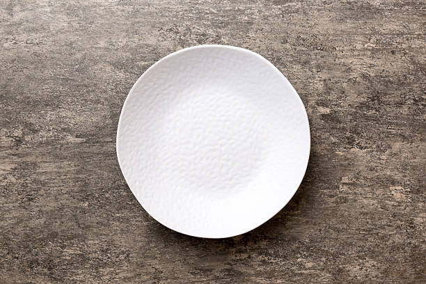 istock Top view of empty light plate on cement background. Empty space for your design 2251118389
