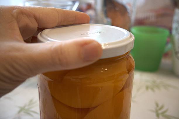 istock Peach compote in a jar, close-up 2251118542