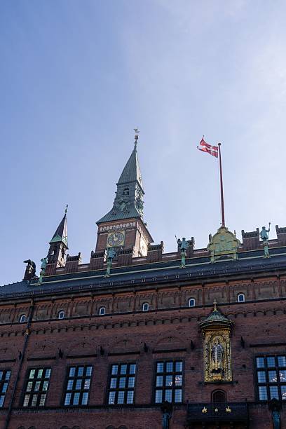 Vibrant danish flags decorate a street in copenhagen, denmark, showcasing national pride and cultural heritage