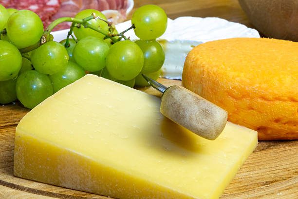 Cheese platter with different kinds of soft cheese and grapes
