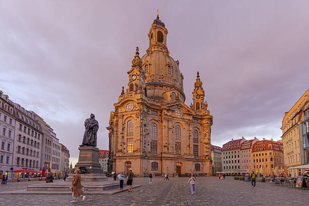 Dresden, Germany - September 16, 2025: Sunset scene of the Neumarkt square, with Frauenkirche church, Martin Luther Statue, locals and visitors, in Dresden, Saxony, Germany