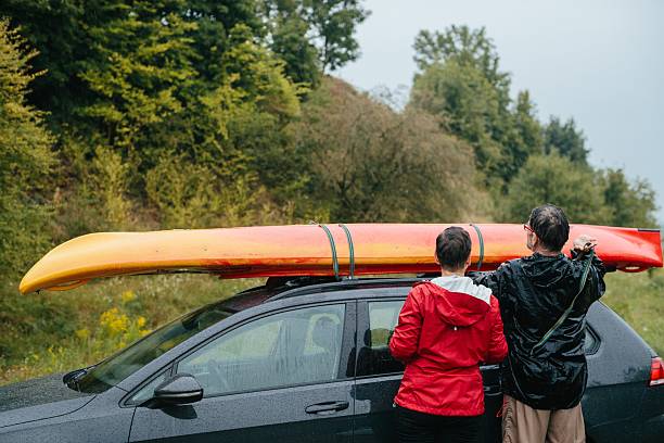 istock Senior couple preparing kayak on car in rain 2251121340